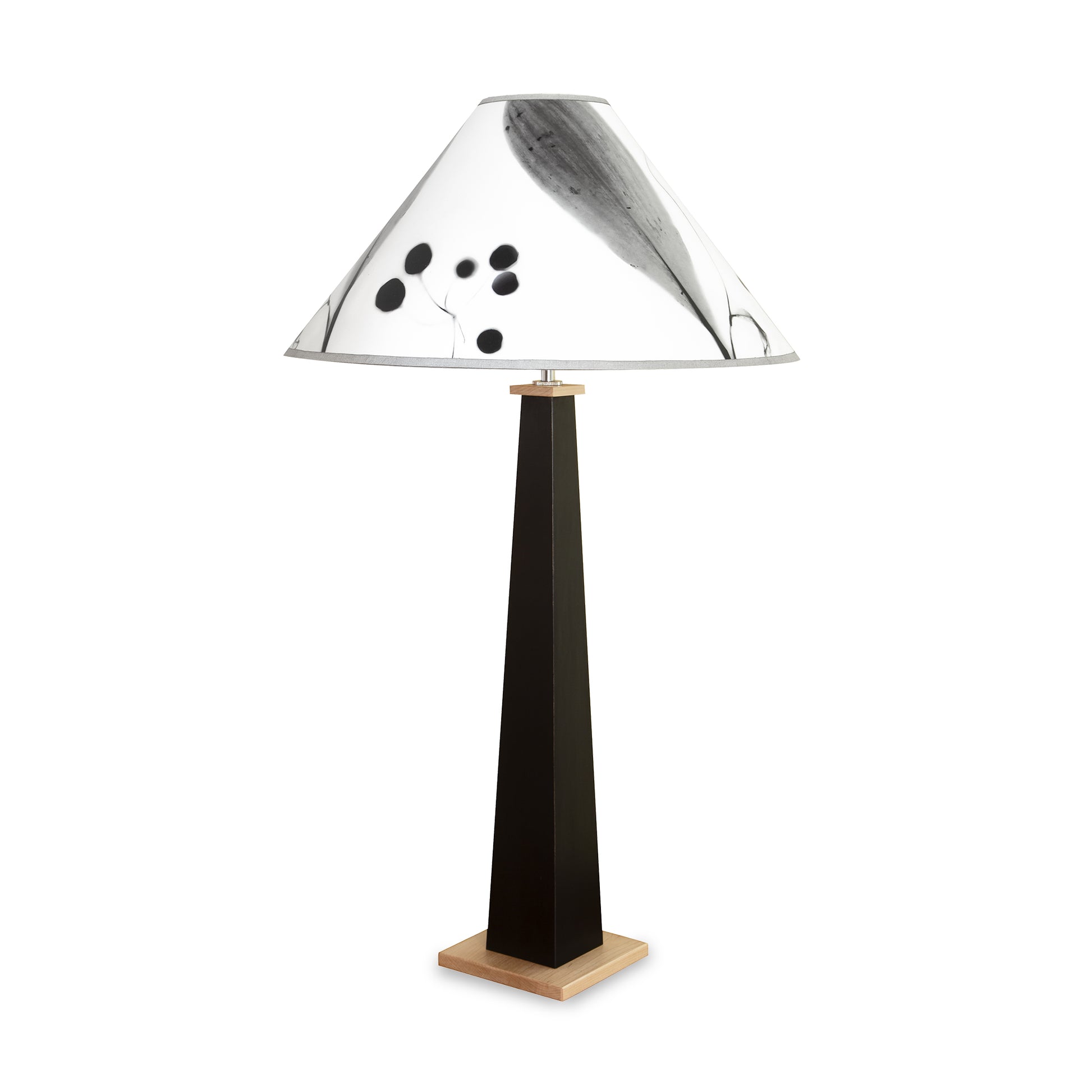 Dance of Life Table Lamp by Rock River Studio with a black tapered base and a conical shade featuring abstract black and gray patterns.