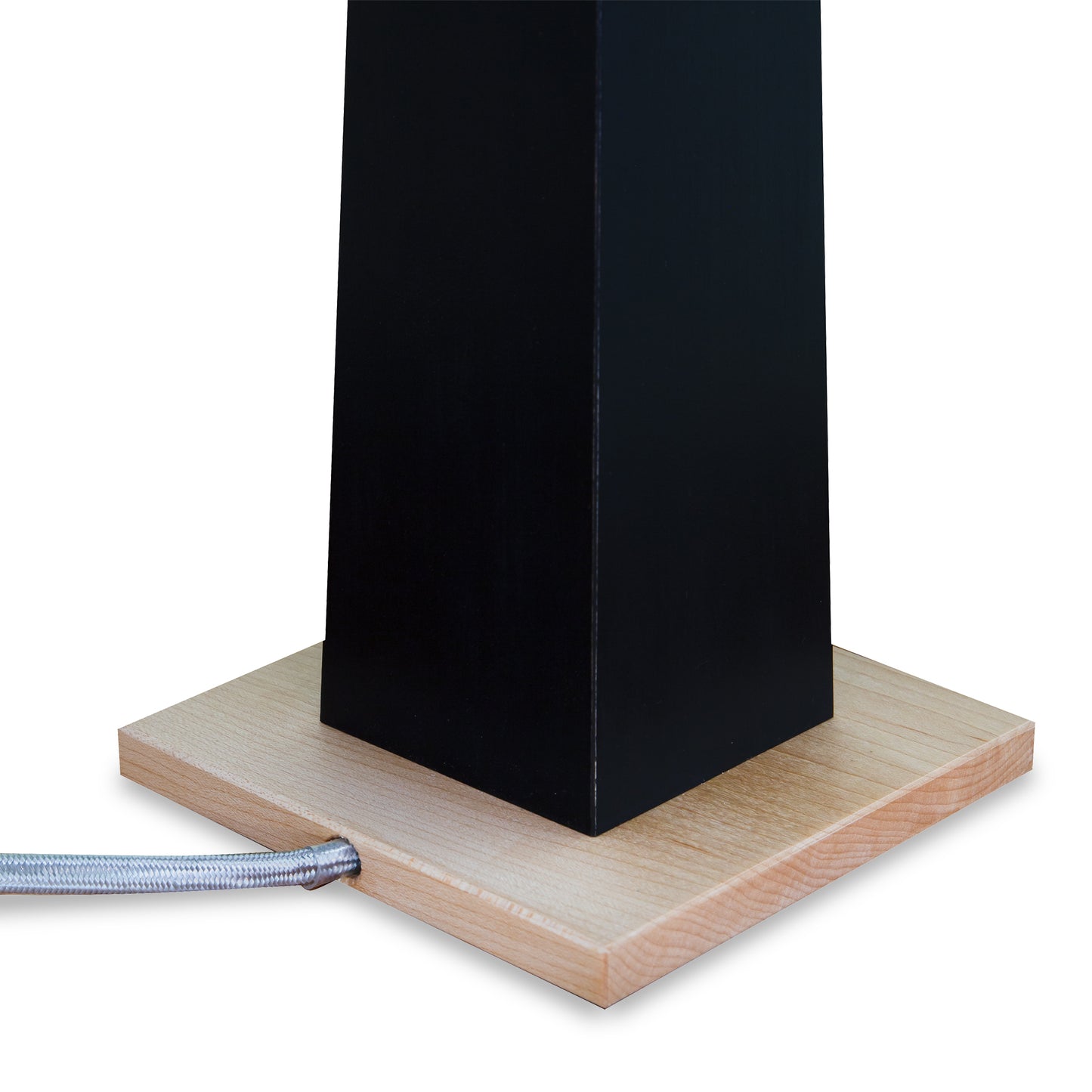 Dance of Life Table Lamp by Rock River Studio, with a black rectangular column and light wood base, accented by a silver braided cable.