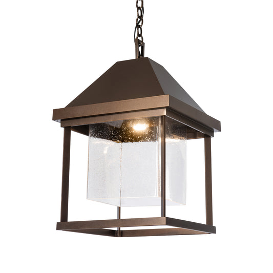 Dorset Dark Sky Friendly Outdoor Lantern by Hubbardton Forge featuring a pyramid top, clear glass panels, and exposed bulb design for a modern look.