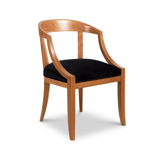 A wooden chair with black velvet upholstered seat.