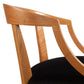 A wooden chair with a black velvet seat.