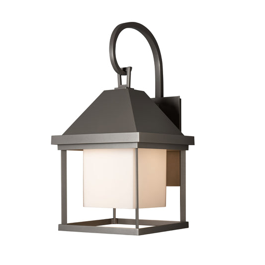 Hubbardton Forge Dorset Medium Dark Sky Friendly Outdoor Sconce with a metal frame, square top, and frosted glass shade designed for outdoor lighting.