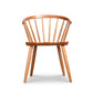 The Dover Curveback Windsor Chair - Display Model by Vermont Woods Studios is a wooden dining chair that boasts a curved spindle back and four straight legs. Its minimalist design features smooth lines and a natural wood finish. Made from sustainable solid wood, the flat seat and ergonomic backrest with multiple vertical slats fan outward for added comfort.