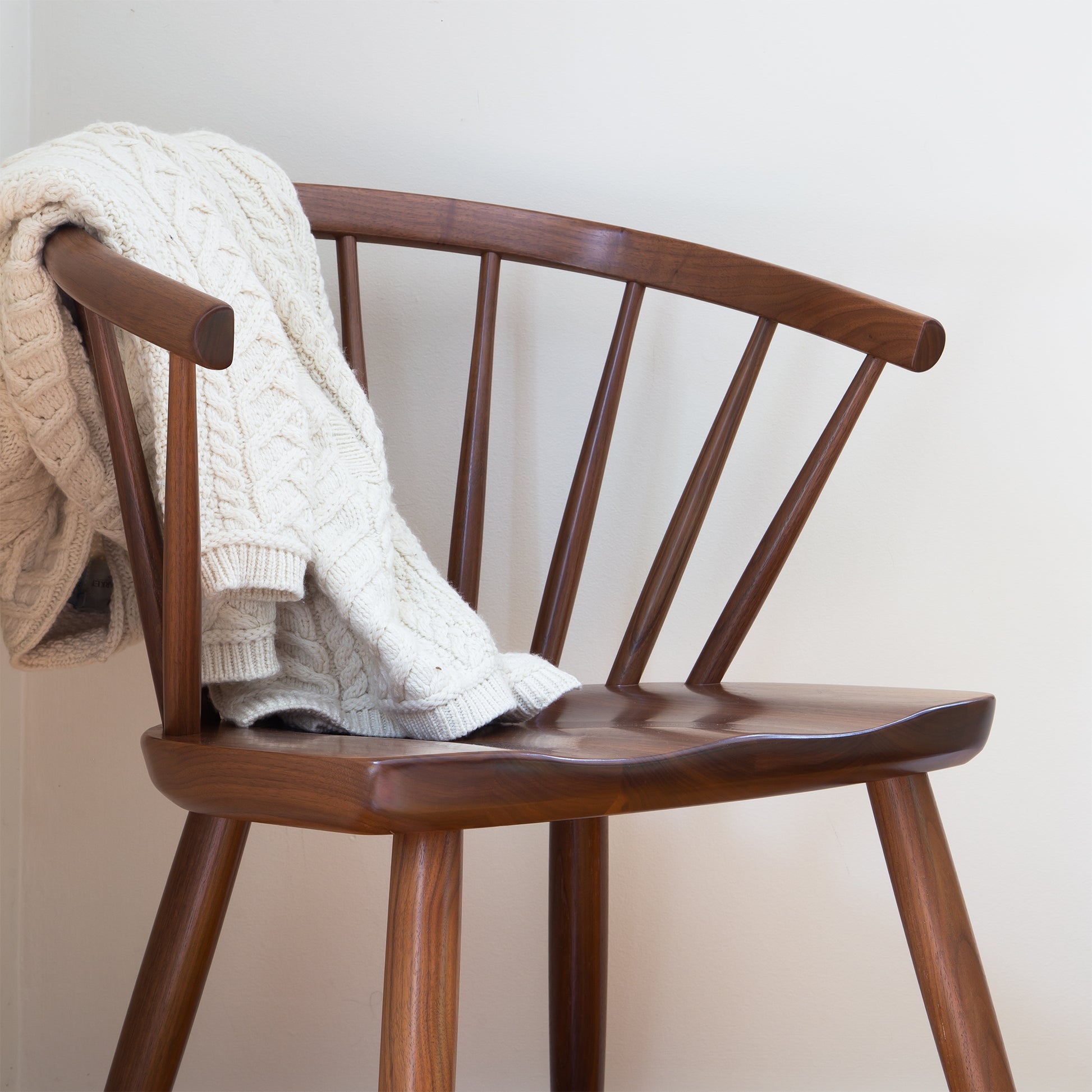Dover Curveback Windsor Chair by Vermont Woods Studios, American made with expert craftsmanship, shown partially covered by a cream cable knit sweater.