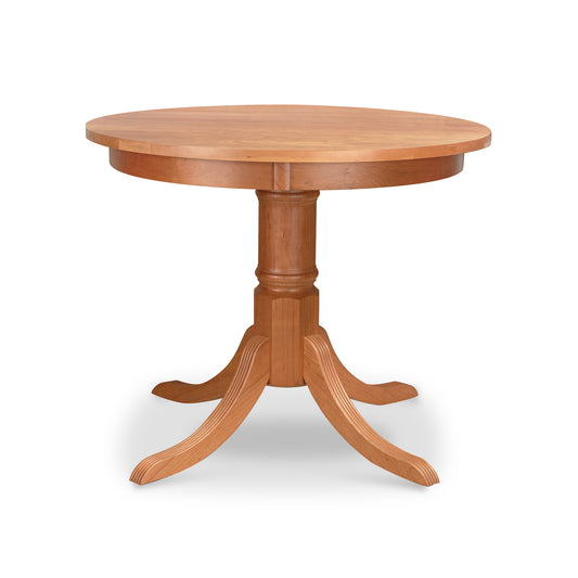 A Duncan-Phyfe Round Pedestal Dining Table by Lyndon Furniture with a hardwood base.