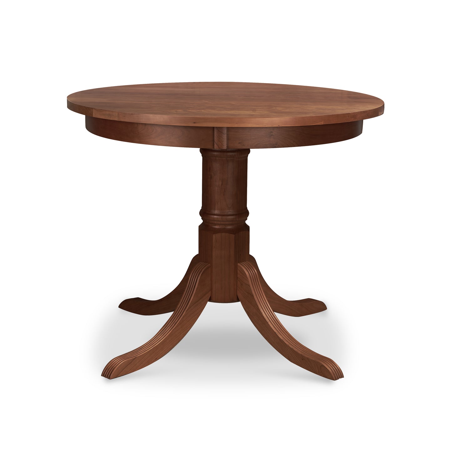 A Duncan-Phyfe Round Pedestal Dining Table from Lyndon Furniture, with a wooden base, perfect for those looking for a sturdy and traditional addition to their dining space. Its solid top ensures durability and its timeless design brings to mind the classic Duncan-Phyfe style.