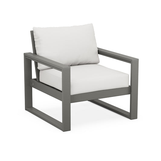 A modern POLYWOOD® EDGE Club Chair with a dark gray metal frame and white cushions, featuring weather-resistant construction, set against a plain white background.