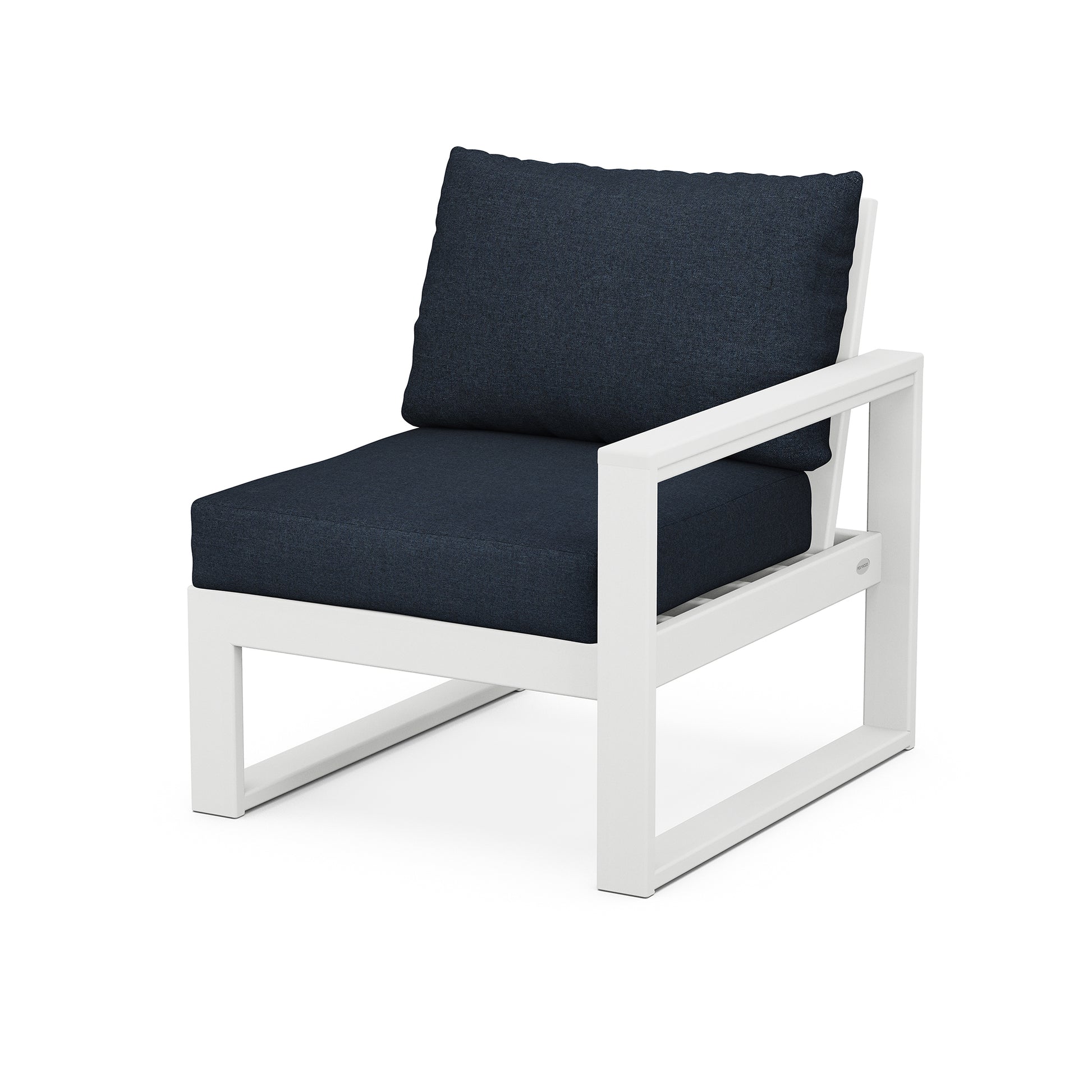 A modern white frame outdoor chair with a thick, dark blue cushion and a matching back pillow, isolated on a white background. Product Name: POLYWOOD EDGE Modular Right Arm Chair Brand Name: POLYWOOD