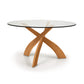A modern Entwine Round Glass Top Dining Table with a wooden cross base design by Copeland Furniture, isolated on a white background.