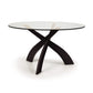 A round glass dining table with a black base.