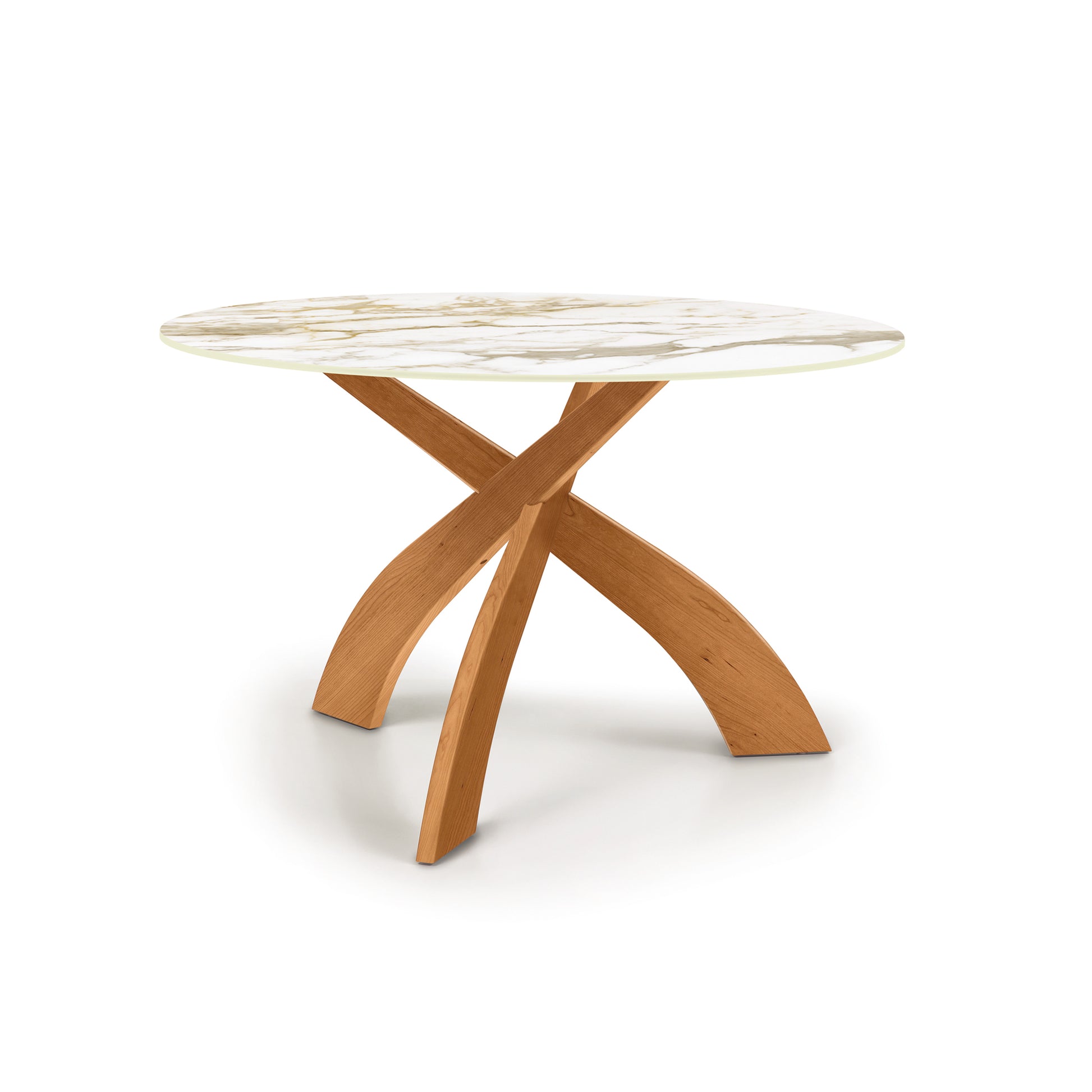 Entwine Round Table with sintered stone top and artistic cherry wood X-shaped base by Copeland Furniture.