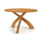 Entwine Round Solid Top Table by Copeland Furniture with three curved wood legs, crafted in America, highlighting elegant design and expert craftsmanship.