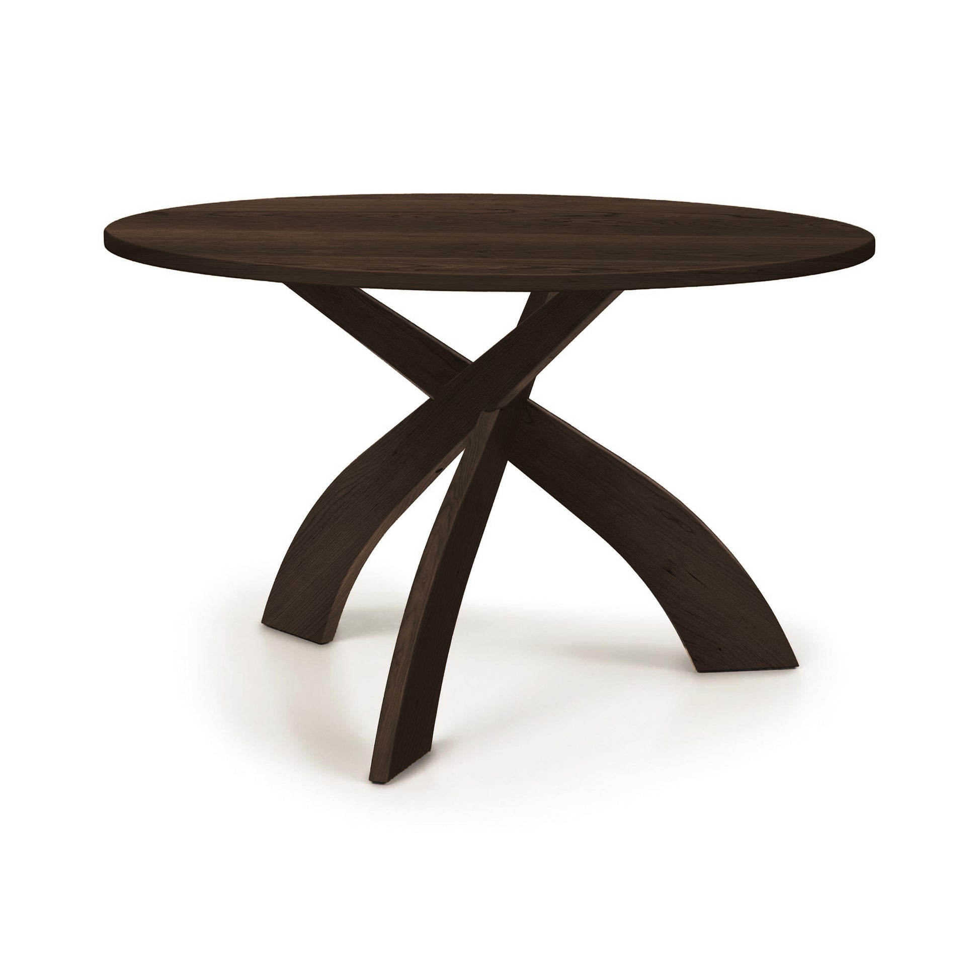 Entwine Round Solid Top Table by Copeland Furniture with three elegant curved legs, shown clearly to highlight its American-made craftsmanship.