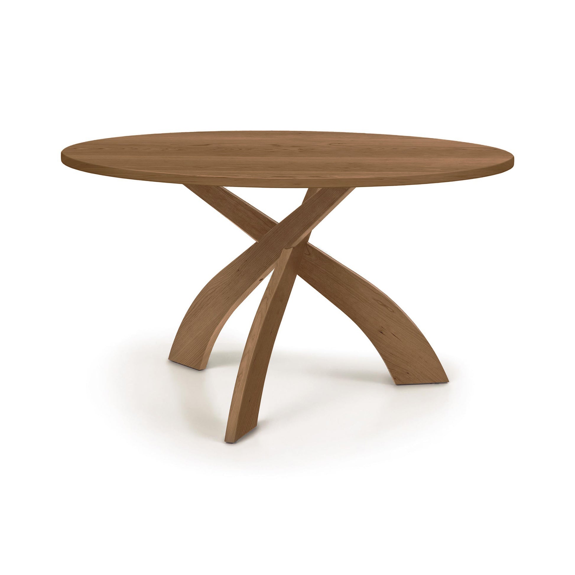 Entwine Round Solid Top Table by Copeland Furniture, showcasing a sleek round surface and three gracefully curved, intersecting solid wood legs.