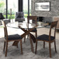 Copeland Entwine round glass top dining table with three wooden chairs featuring dark cushions, showcasing elegant craftsmanship and contemporary design.