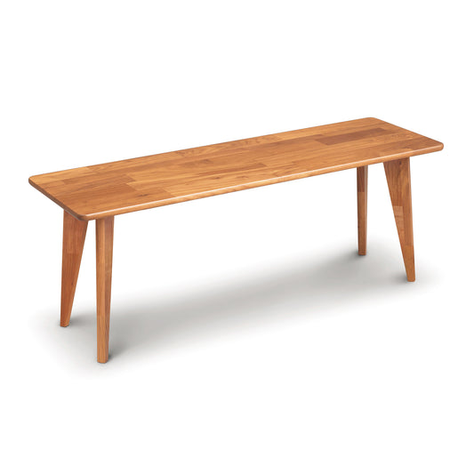 A Copeland Furniture Essentials Bench with Wood Legs with a simple, elongated rectangular top and tapering legs, isolated on a white background.