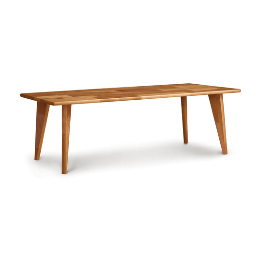 A Copeland Furniture Essentials Coffee Table with Wood Legs on a white background, featuring a smooth tabletop and angled legs.
