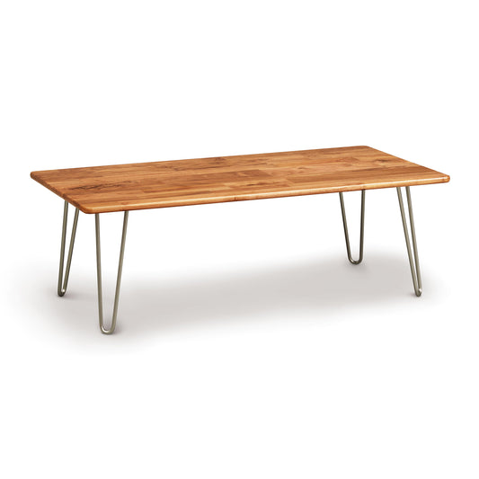 A wooden Copeland Furniture Essentials Rectangle Coffee Table with metallic legs, showcasing natural wood characteristics on a white background.