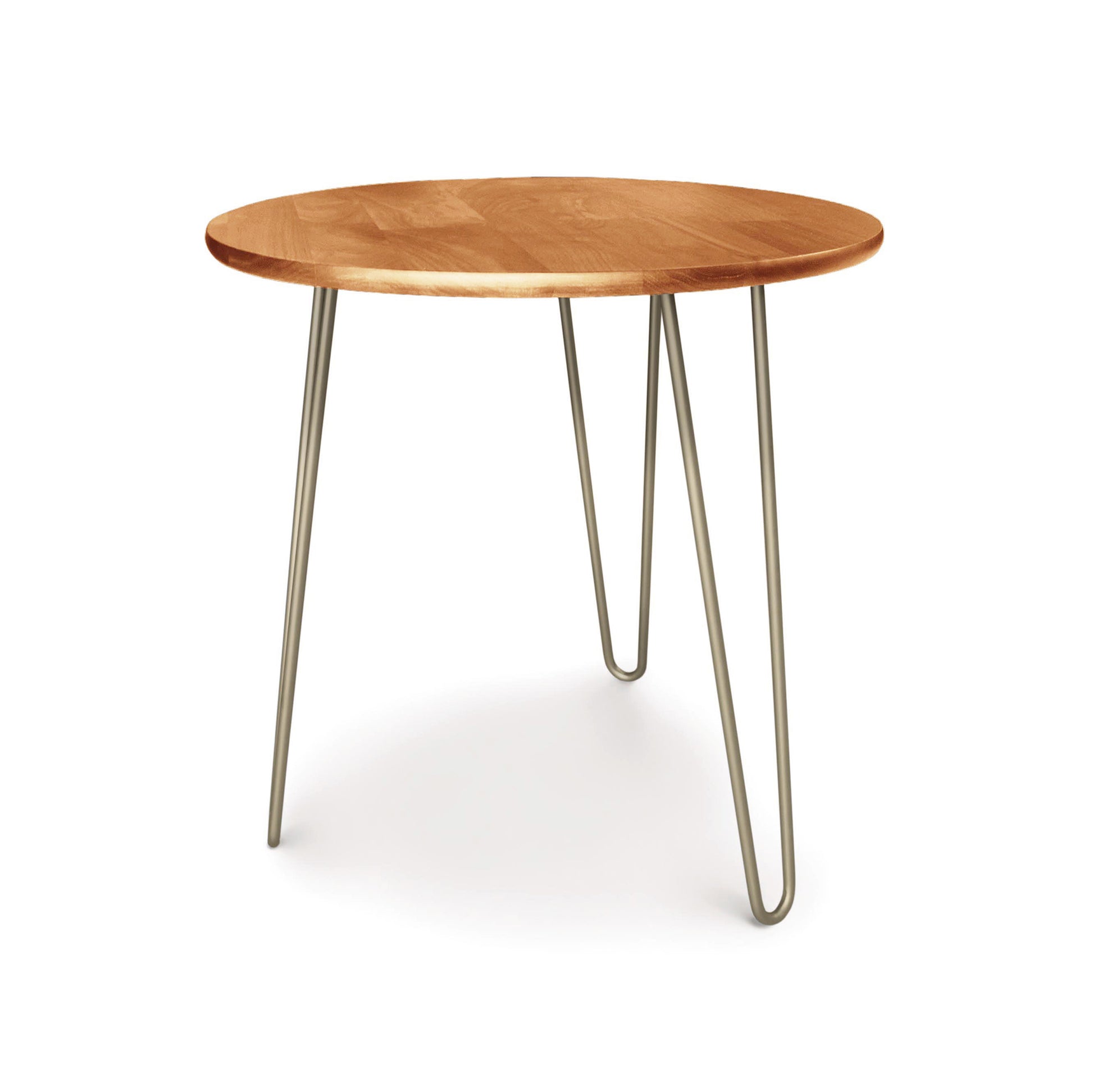 A modern Essentials Round End Table from Copeland Furniture with three metal hairpin legs, embodying mid-century modern design, on a white background.