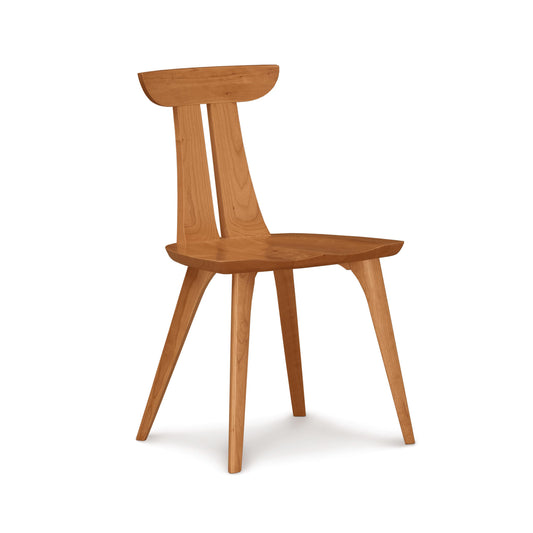 The Copeland Furniture Estelle Chair showcases a sleek mid-century modern design, crafted from beautiful cherry wood. Placed against a clean white background, this wooden dining chair adds an elegant touch.