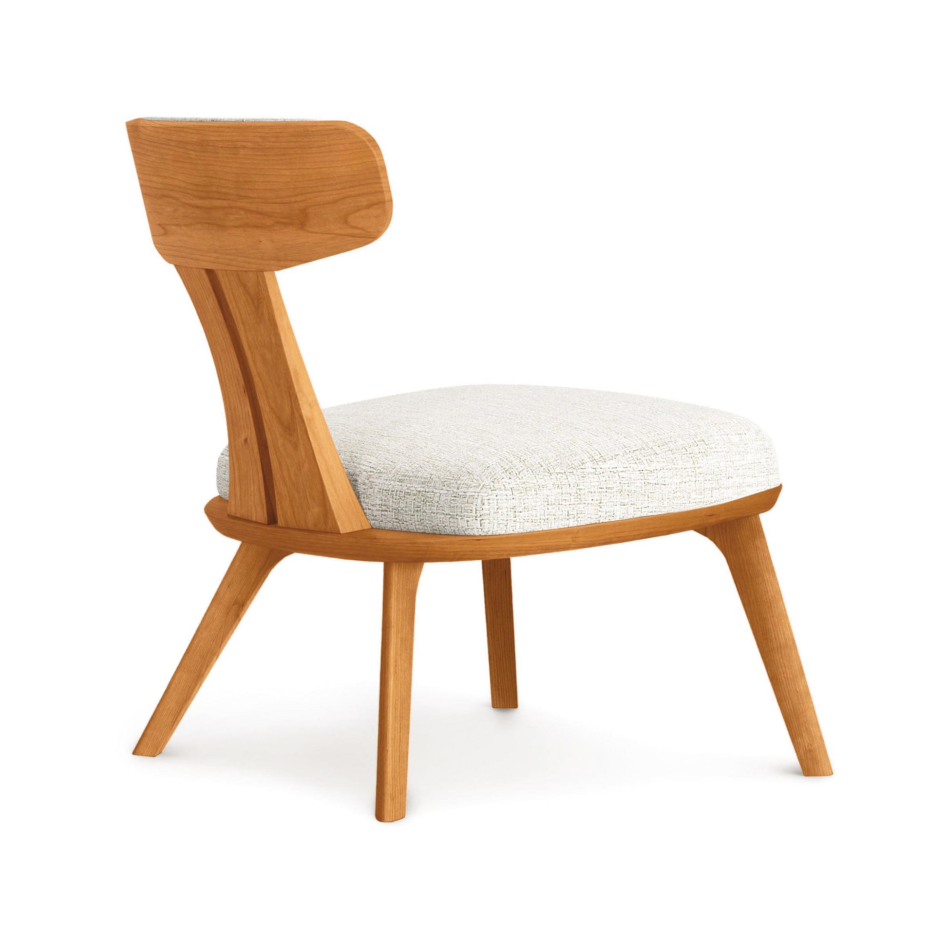 Estelle Lounge Chair by Copeland Furniture with angled legs and a sculpted curved backrest, expertly crafted in solid wood for modern comfort.