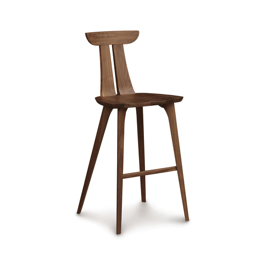 Estelle Bar Stool by Copeland Furniture crafted from American hardwood with four angled legs, curved backrest, and footrest.