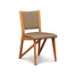 Exeter Chair by Copeland Furniture featuring a modern design with a brown upholstered seat and backrest supported by a sleek white base.