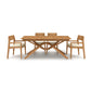 A Exeter Extension Dining Table by Copeland Furniture with four chairs on a white background.