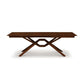 Exeter Extension Dining Table with wooden top and X-shaped base crafted from North American hardwood by Copeland Furniture.