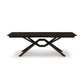 Exeter Extension Dining Table by Copeland Furniture with a rectangular top and distinctive geometric X-shaped base, crafted from dark North American hardwood.