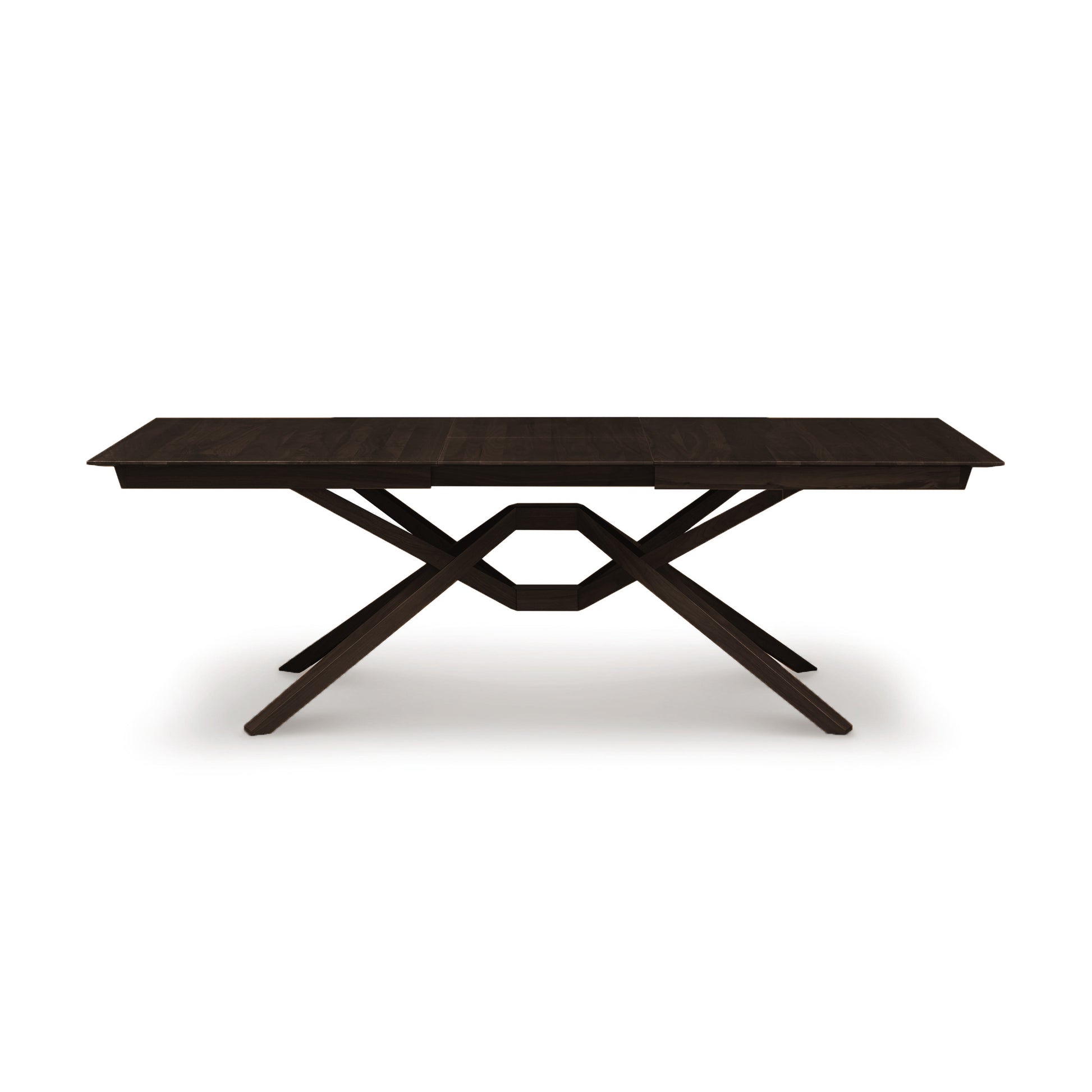 Exeter Extension Dining Table by Copeland Furniture with a rectangular top and distinctive geometric X-shaped base, crafted from dark North American hardwood.