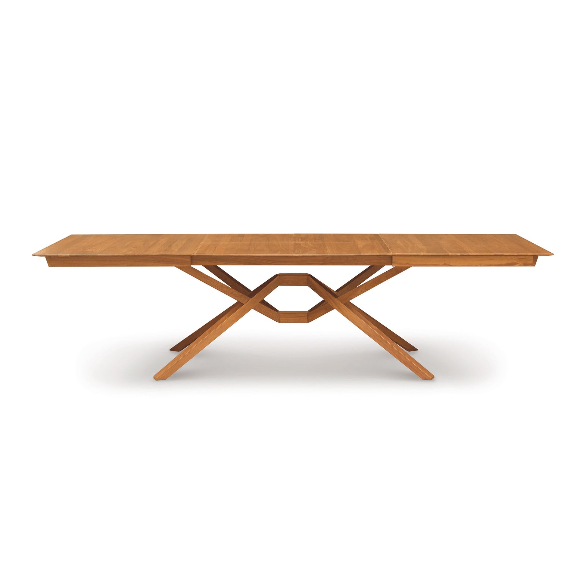 A wooden table with a cross leg on it.