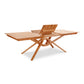 Exeter Extension Dining Table by Copeland Furniture crafted from North American hardwood with a butterfly leaf and distinctive crisscross legs.