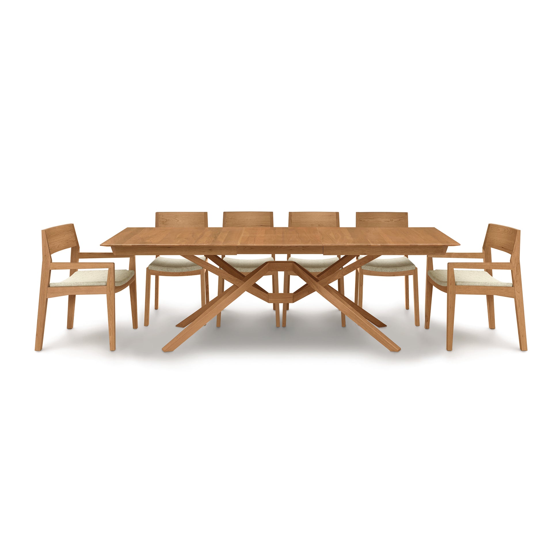 A modern Exeter Extension Dining Table by Copeland Furniture with six chairs and an extension feature.