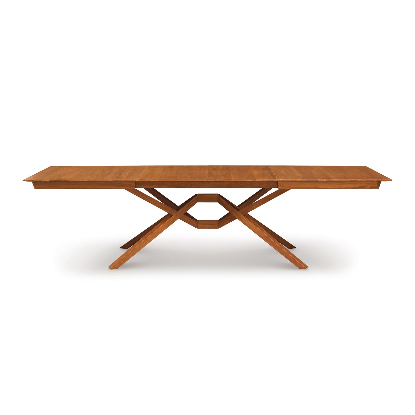 Exeter Extension Dining Table with geometric crisscross base and butterfly leaf extension, crafted from North American hardwood by Copeland Furniture.