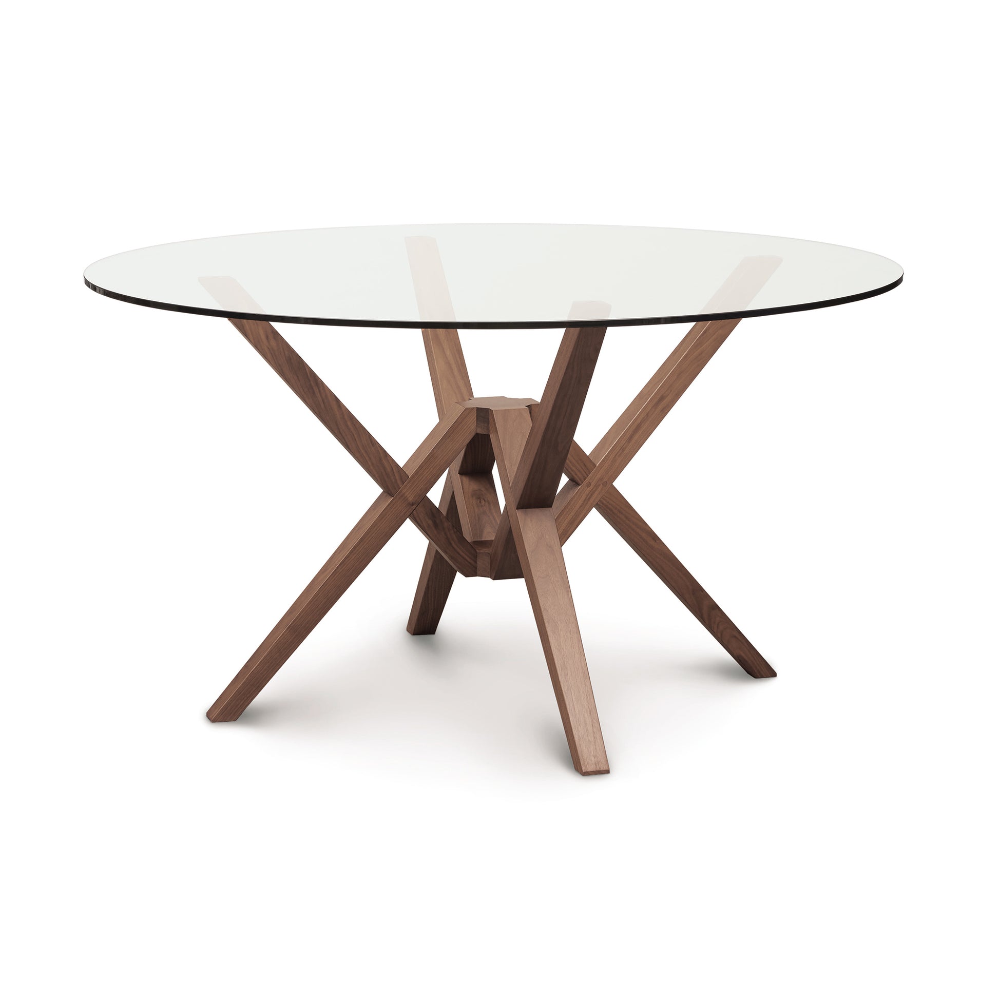 The Copeland Furniture Exeter Round Glass Top Table is a modern dining table with innovative engineering, featuring a sleek glass top and wooden legs.