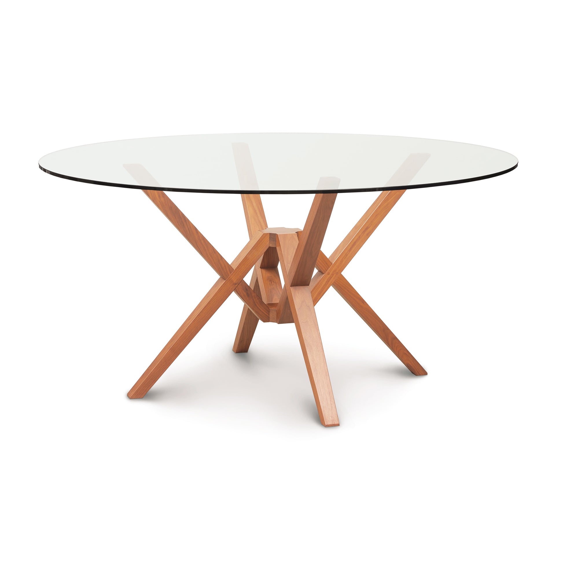 The Copeland Furniture Exeter Round Glass Top Table features innovative engineering and a unique isometric design that showcases wooden legs supporting a sleek, yet sturdy glass top.