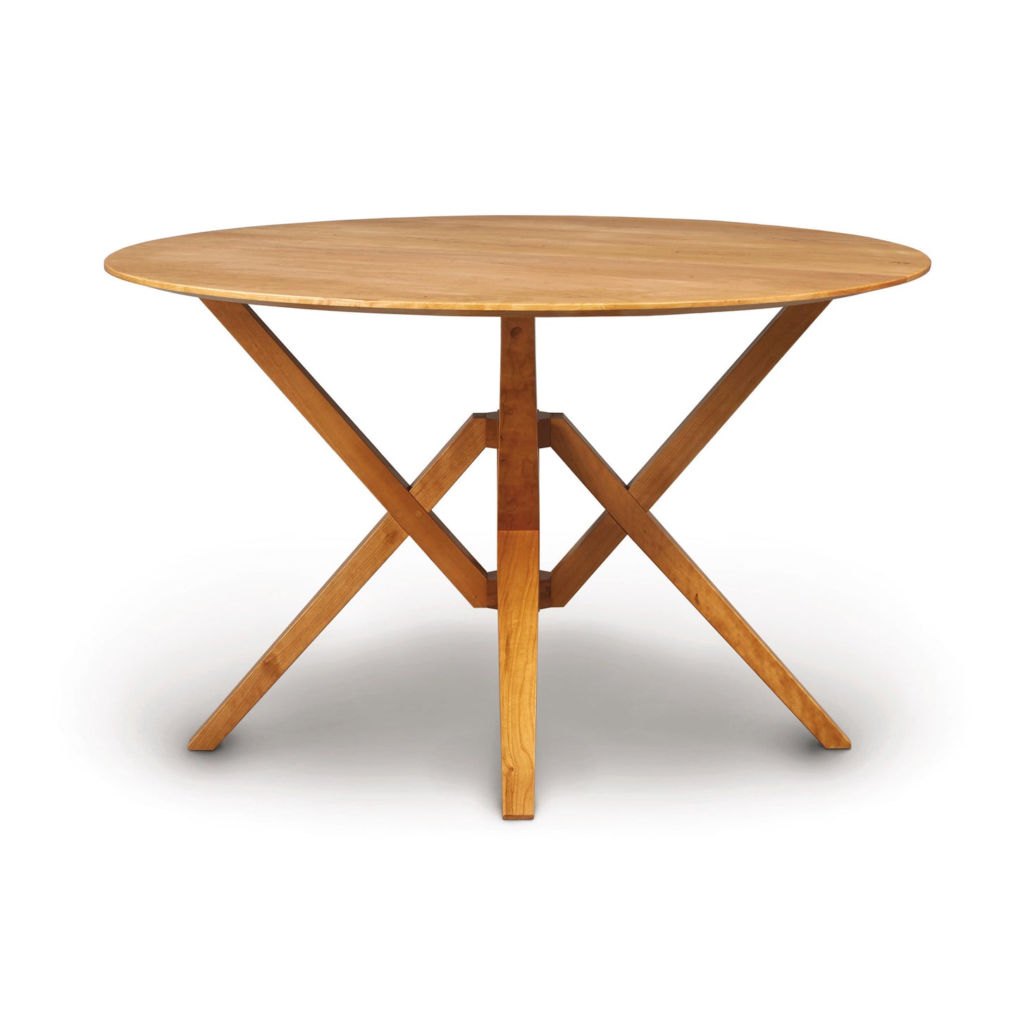A round wooden Copeland Furniture Exeter Round Solid Top Dining Table with a cross-brace leg design, crafted from sustainably harvested hardwoods, isolated on a white background.