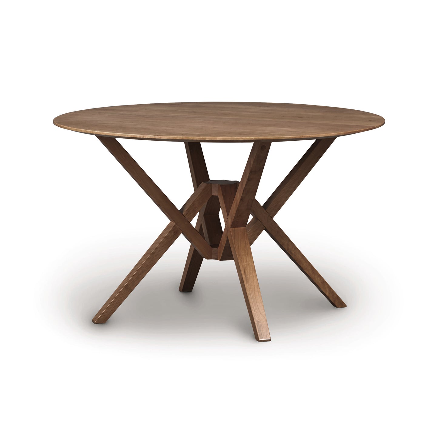A sustainably harvested hardwoods Copeland Furniture Exeter Round Solid Top Dining Table with a cross-brace base, isolated on a white background.