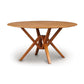 A sustainably harvested hardwoods, Copeland Furniture Exeter Round Solid Top Dining Table with a cross-leg design isolated on a white background.