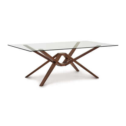 Exeter Rectangular Glass Top Table by Copeland Furniture showcasing a geometric hardwood base and modern isometric design.
