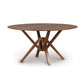 An Copeland Furniture Exeter Round Solid Top dining table with a crossed leg design made from sustainably harvested hardwoods, presented against a white background.