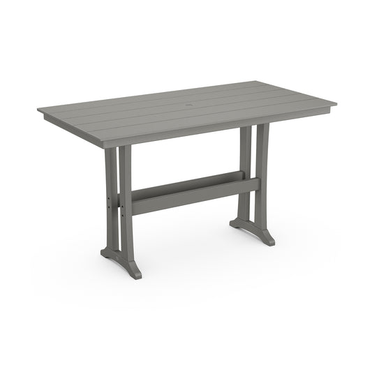A modern, height-adjustable desk with a gray tabletop made from POLYWOOD® lumber and metallic legs, isolated on a white background. The POLYWOOD Farmhouse Trestle 37" x 72" Bar Table features a minimalist design with a horizontal stabilizing bar.