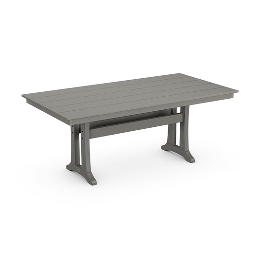 A modern, rectangular outdoor dining table with a gray slatted POLYWOOD® Farmhouse Trestle 37" x 72" top and robust metal legs, isolated on a white background.