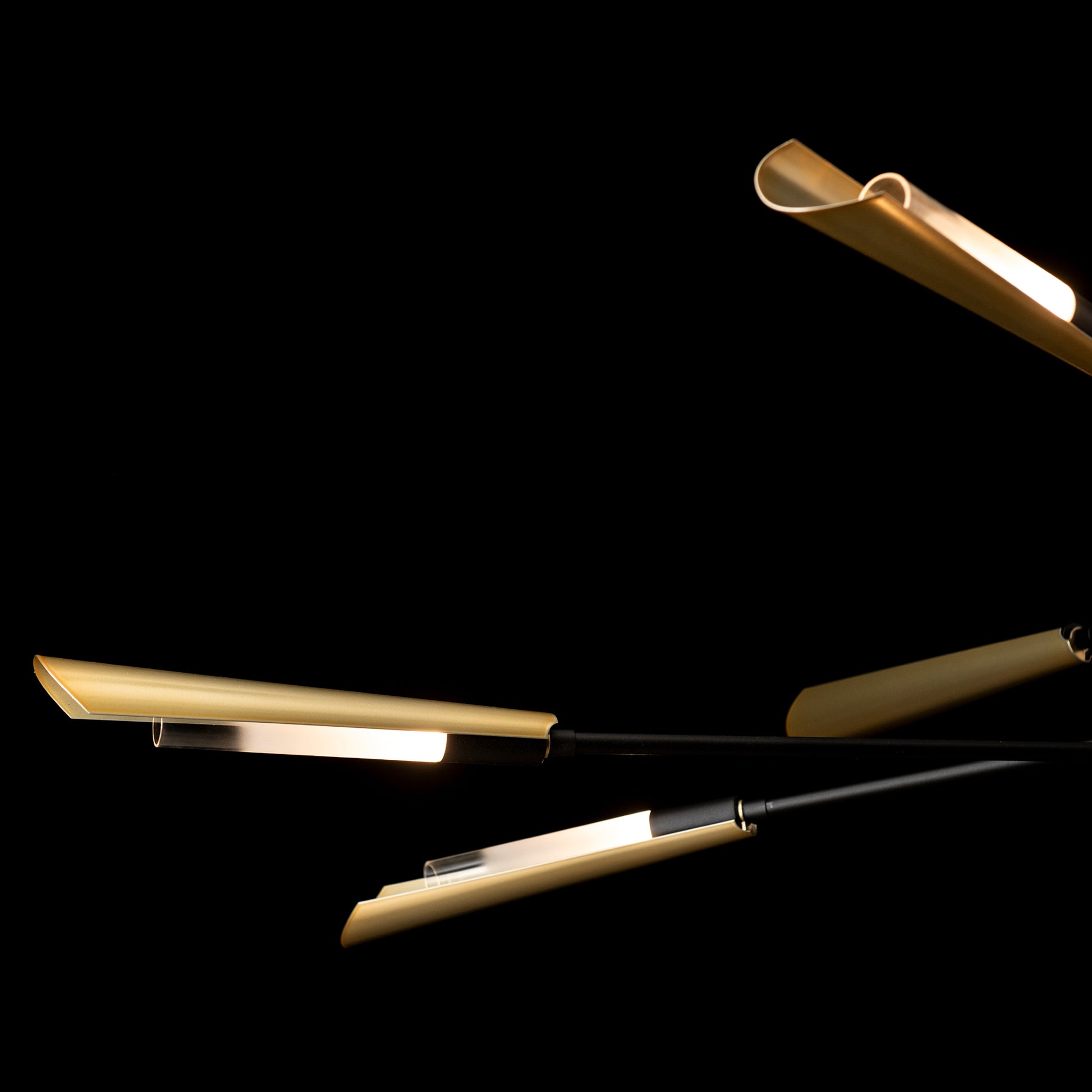 Hubbardton Forge Flight 10-Light Pendant with gold hand-forged steel lights and black rods, expertly crafted for modern American-made interiors.