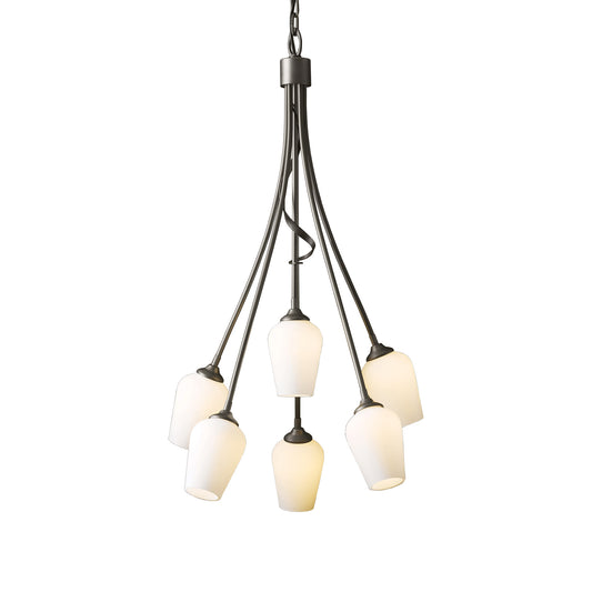 A Flora 6-Arm Chandelier by Hubbardton Forge with a draping form and frosted glass shades.