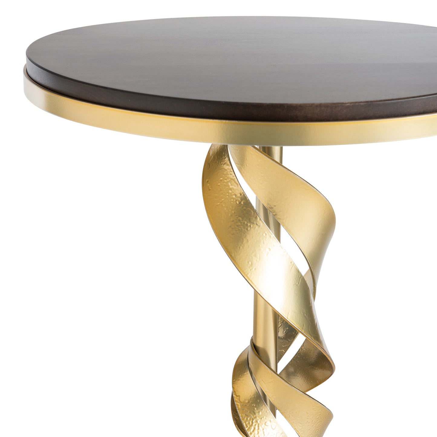 Close-up of the Folio Wood Top Accent Table by Hubbardton Forge, crafted with Vermont Maple Wood. It features a dark wooden top and a modern spiraling brass-finished support. The elegant design highlights the gold support twisting upwards to seamlessly connect to the top.