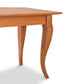 A French Country Lyndon Furniture wooden dining table with a curved leg and a French Country End Table.