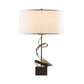 A Hubbardton Forge Gallery Spiral Table Lamp with a metal base and a white shade. Handcrafted in Vermont.