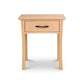 Green Mountain 1-Drawer Nightstand in handcrafted light wood featuring a single drawer with a dark, curved handle.